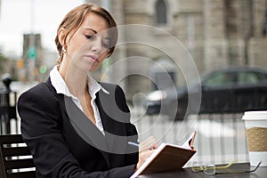 Business woman writing in her journal