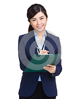 Business woman writing information on clipboard