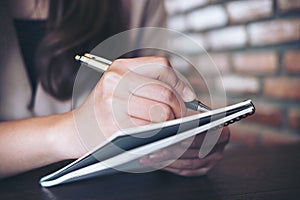 A business woman writing and taking note on notebook in office