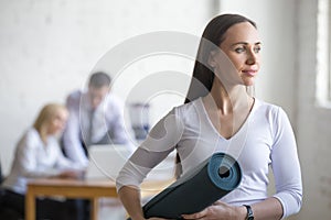 Business woman with yoga mat