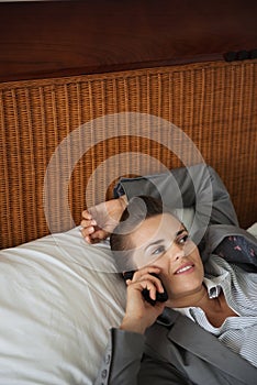 Business womanin hotel room talking cell phone