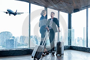 Business women and businessmen leave luggage and meet at the airport to fly to see work in foreign countries.