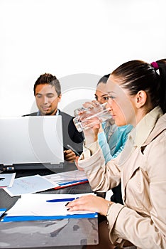 Business women drinking water at meeting