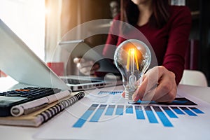 Business women entrepreneurs show creative business strategies with light bulbs as a concept.