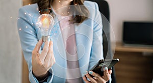 Business women entrepreneurs show creative business strategies with light bulbs as a concept. On the desk in the morning