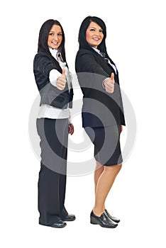 Business women giving thumbs