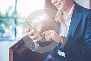 Business women hand are uses a smartphone in office