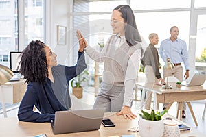 Business women, high five and corporate team celebrate success, win or target achievement in office. Diversity people or