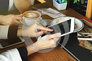 Business women looking at the tablet computer, Colleagues discussing business at cafe, Everywhere is a working place concept