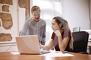 Business women looking worriedly at laptop