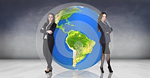 Business women recline on the big earth