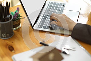 Business women`s hand typing on laptop keyboard. woman working from home