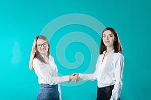 Business woman shaking hands, concept close deal or partnership. Two women partners handshaking after signing business contract.