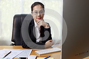 Business women smileing wear glasses sitting at office. business people using computer PC  at office. Business at home concept