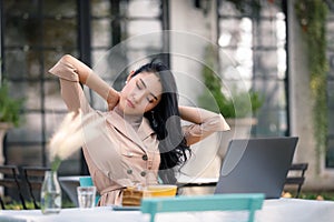 Business women stretch oneself while working on the Computer