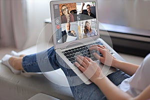 Business woman talking to her colleagues in video conference. Business team working from home using laptop