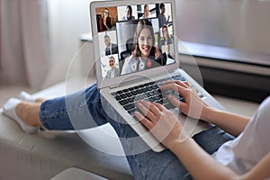 Business woman talking to her colleagues in video conference. Business team working from home using laptop