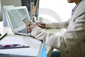 Business women using mobile phones On the table