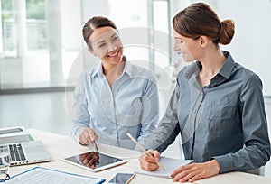 Business women working together on a tablet