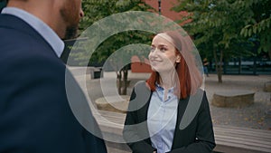 Business work break in city outdoors Caucasian businessman talking friendly with smiling businesswoman happy colleagues