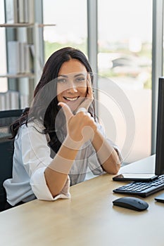 Business and Work place concept. Portrait of smiling businesswoman with show thumb up working with desktop computer and smartphone