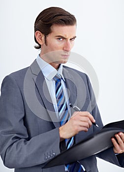 Business, writing or portrait of angry man with document warning in studio for compliance, complaint or white background