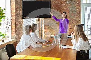 Business young caucasian woman in modern office with team