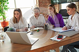 Business young caucasian woman in modern office with team