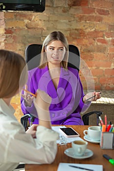 Business young caucasian woman in modern office with team