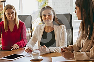 Business young caucasian woman in modern office with team