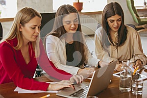 Business young caucasian woman in modern office with team