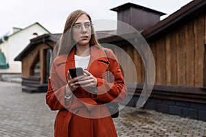 Business young caucasian woman with a smartphone in her hands