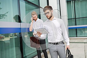 Business young colleagues in shirt walking outdoors