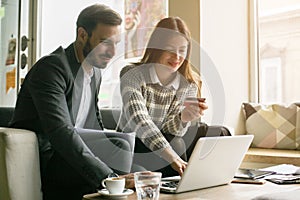 Business young couple working on laptop.