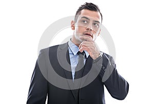 Business: young man in doubt - in suit thinking with hand touching face isolated on white background