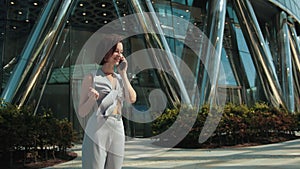 Business, young woman, brunette, holding a smartphone talking, positive decision