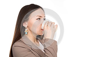 Business young woman drinking from a plastic cup in isolation over white background