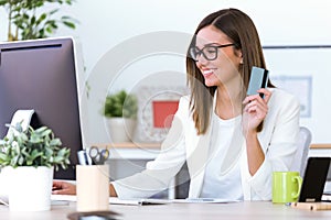 Business young woman using credit card on online shop.