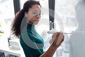 Business young woman working on white board in the office