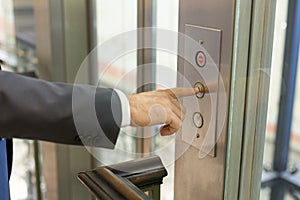 Businessan pressing elevator button