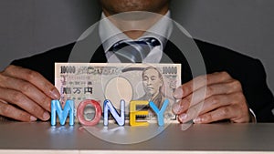 Businessman with 10000 yen bill