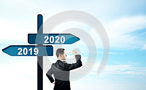 Businessman on 2019, 2020 sign