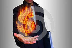 Businessman and abstract fire dollar symbol
