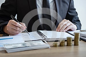 Businessman accountant counting money and making notes at report doing finances and calculate about cost of investment and