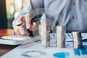 Businessman accountant counting money and making notes at report doing finances and calculate about cost of investment and