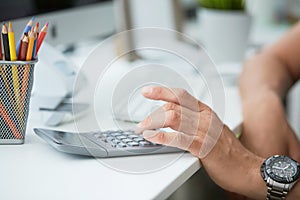 Businessman accountant using calculator and desktop for calculating finance on desk office. Business financial