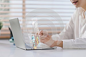A businessman or accountant using laptop to analyze financial investments and business and marketing growth on a data