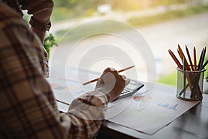 Businessman or accountant working on calculator to calculate bus