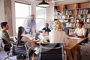 Businessman Addressing Team Meeting Around Table