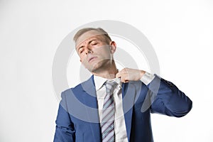 Businessman adjusting his collar as he feels hot